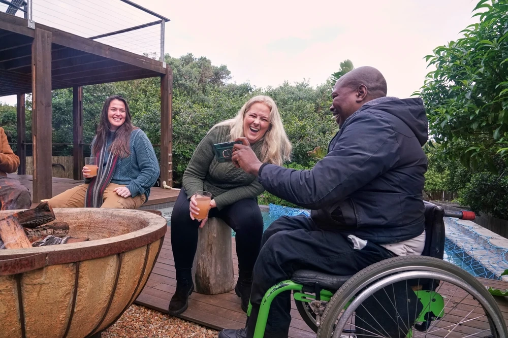 Disabled person with friends having a bonefire
